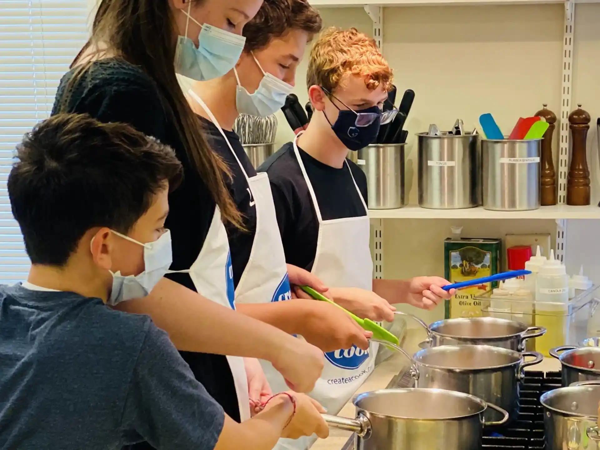a group of people cooking in a kitchen