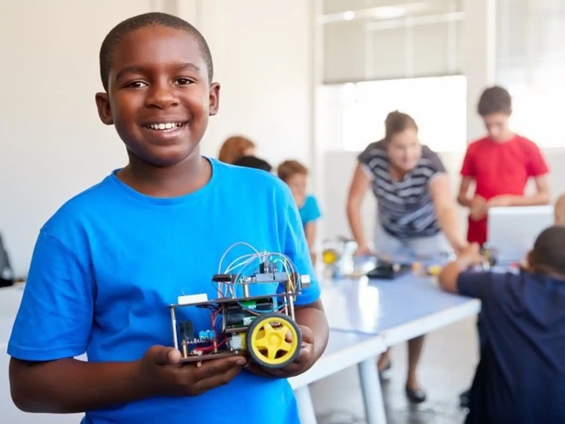 a boy holding a toy car