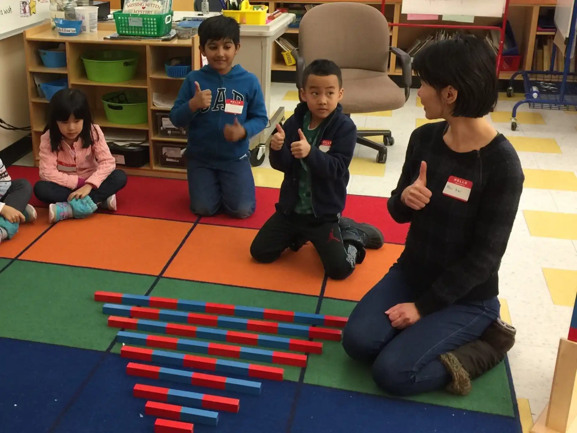 a group of children sitting on the floor playing a game