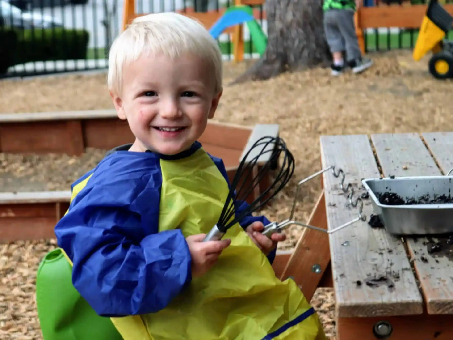 a boy holding a fork and knife
