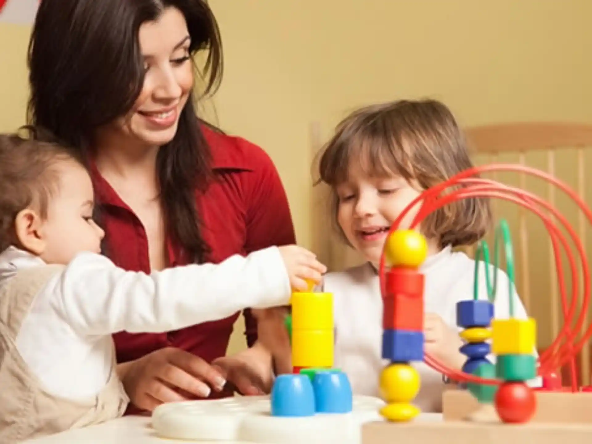 a person and two children playing with toys