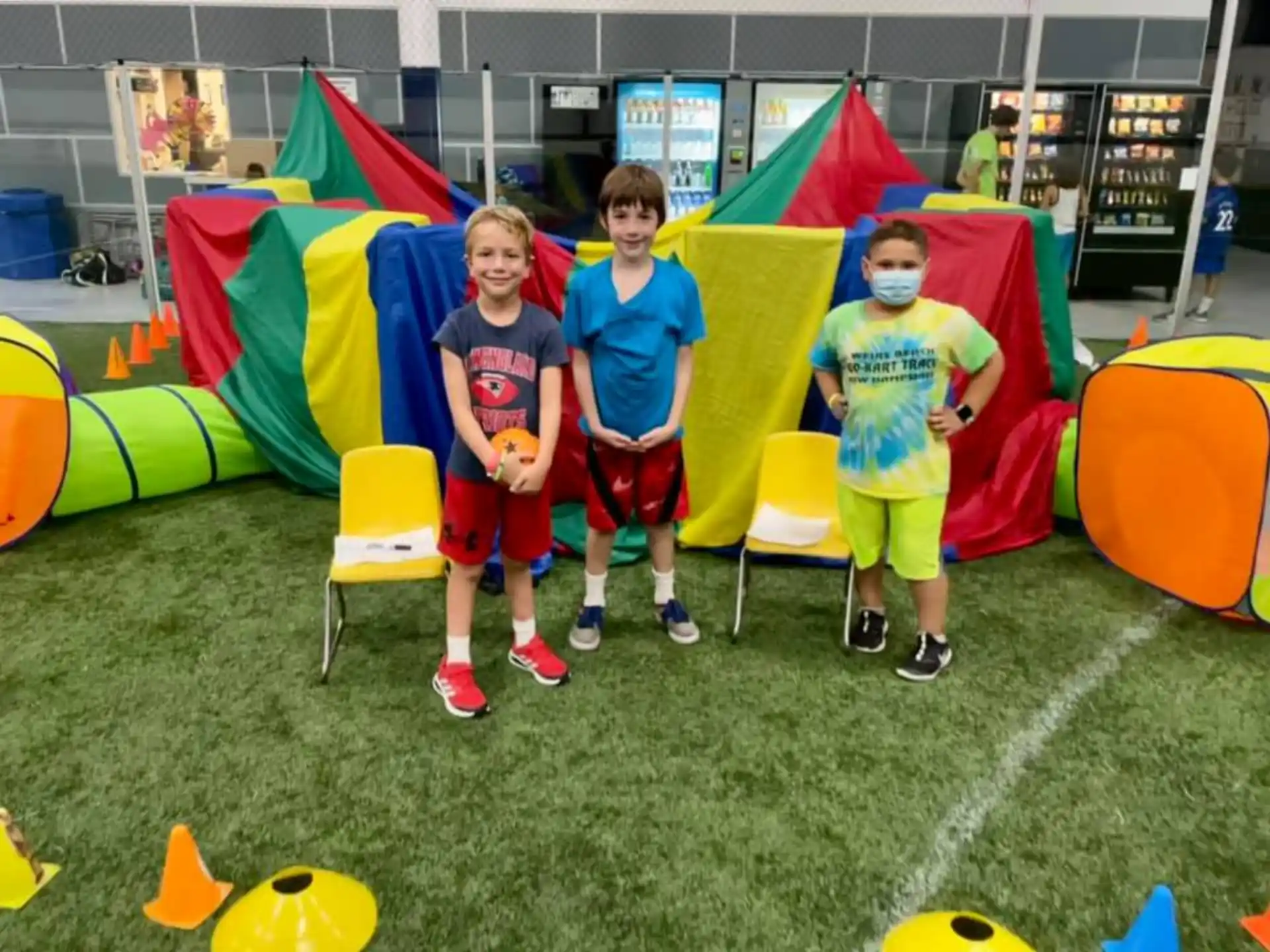a group of boys posing for a picture in front of a tent