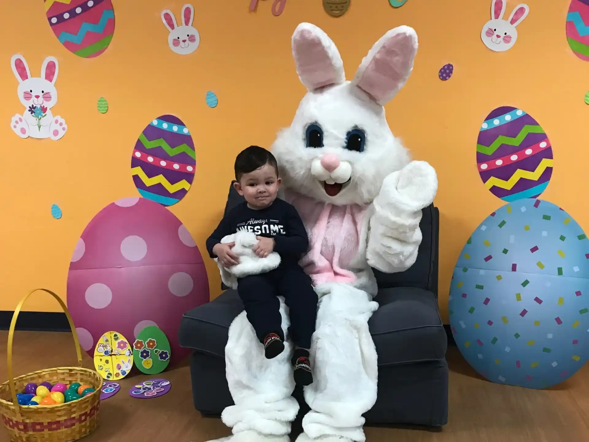 a person sitting on a couch with a person in a rabbit garment