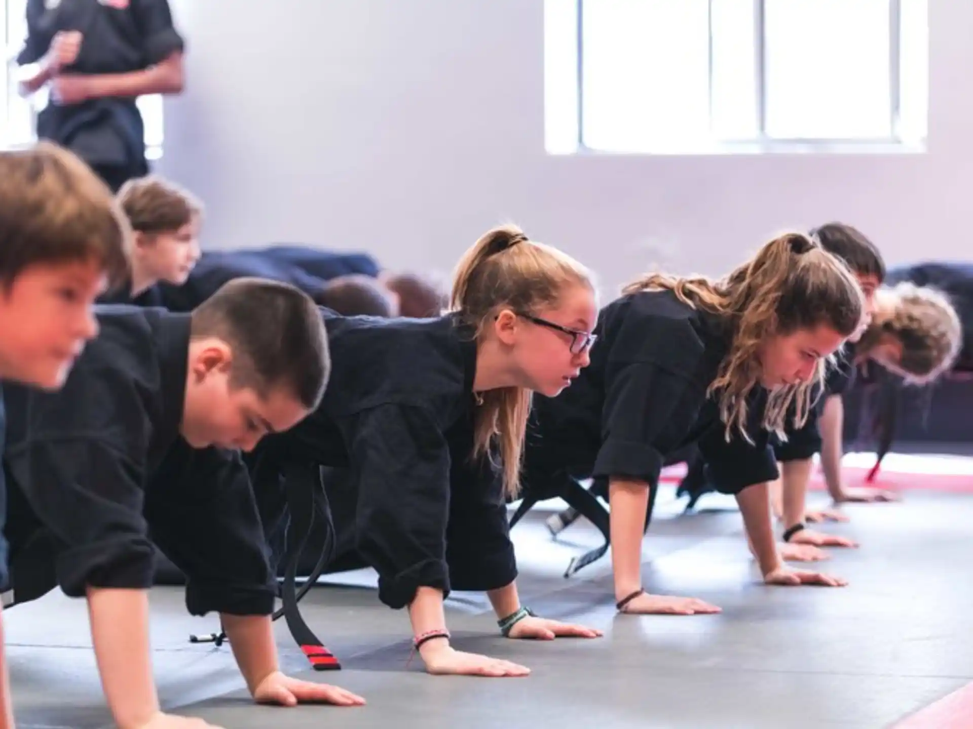 a group of children kneeling on the floor