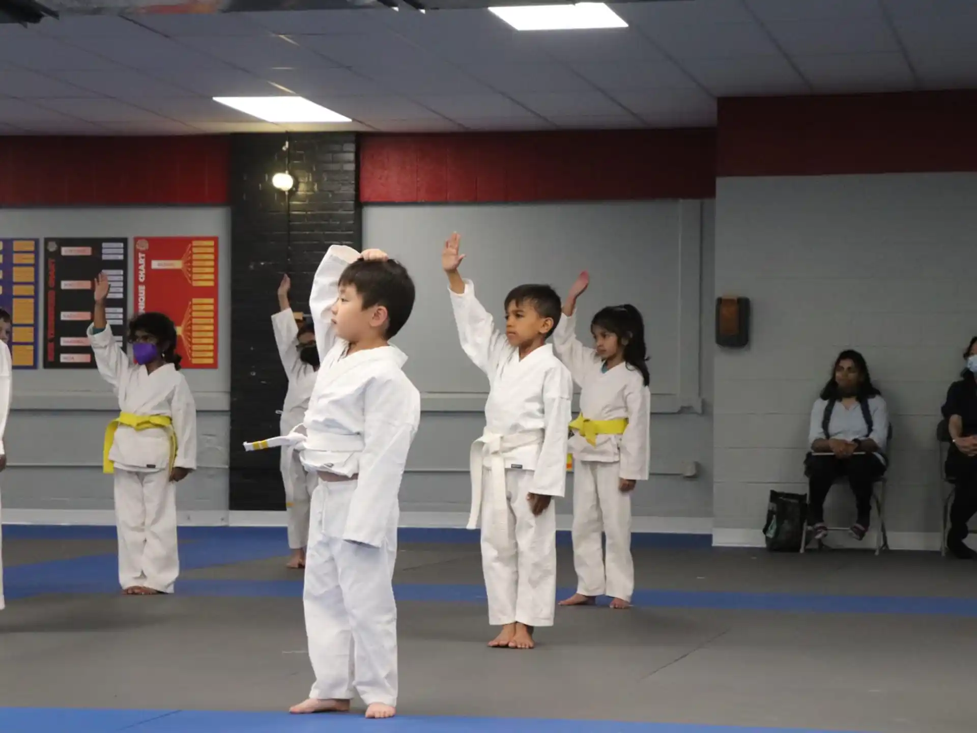a group of children in karate uniforms