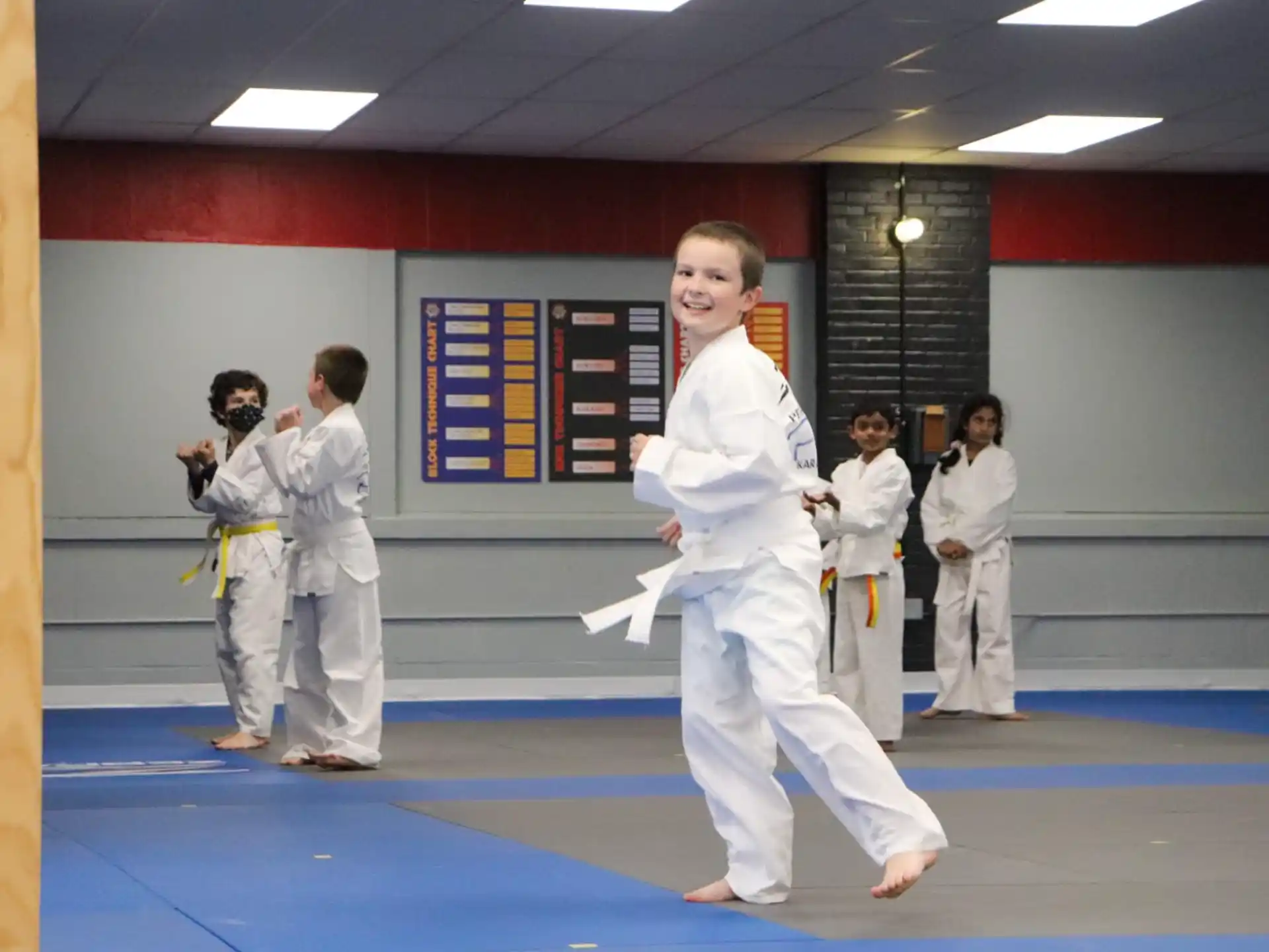 a group of people in white karate uniforms