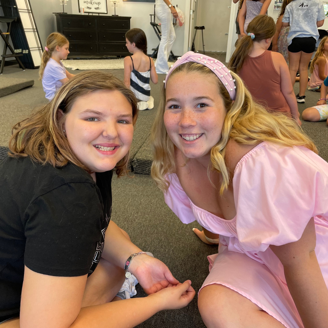 a couple of girls posing for the camera