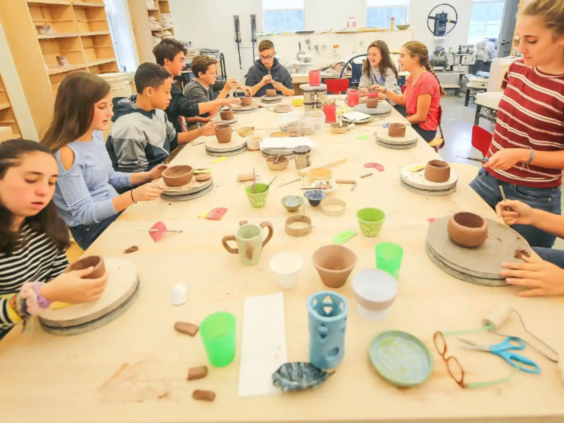 a group of people sitting around a table with food on it