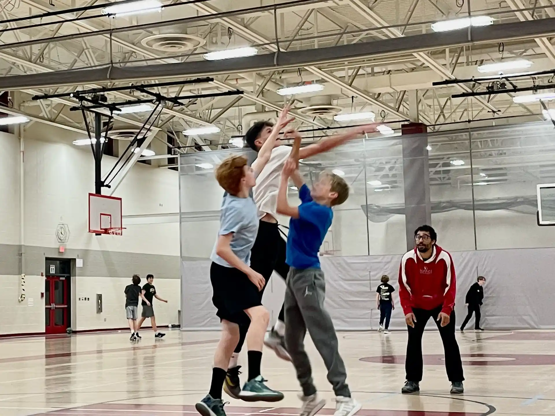 a group of people playing basketball