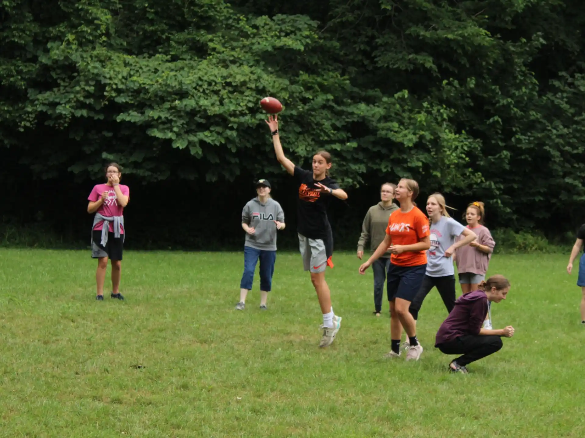 a group of people playing basketball