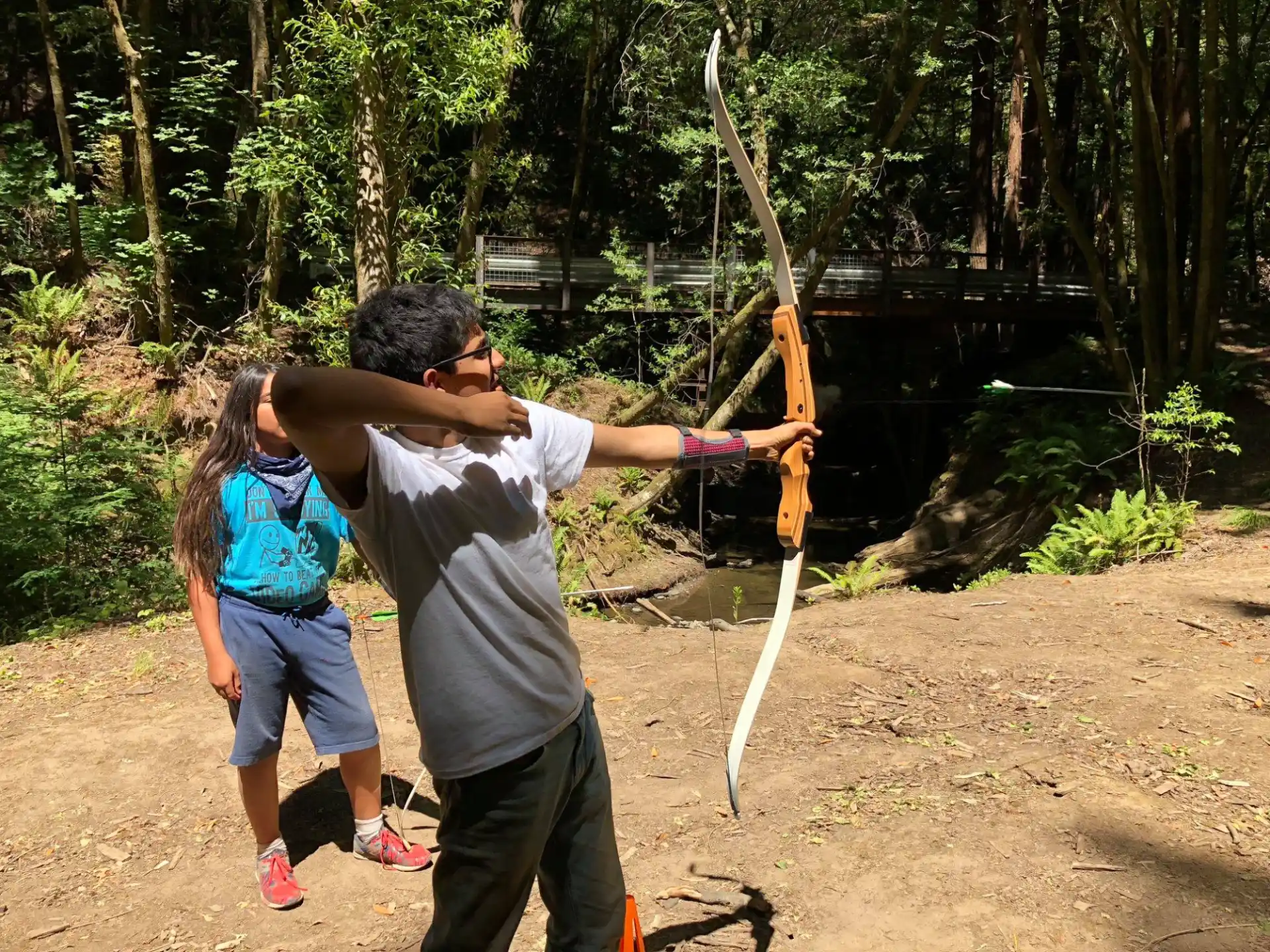 a man and woman holding a bow and arrow
