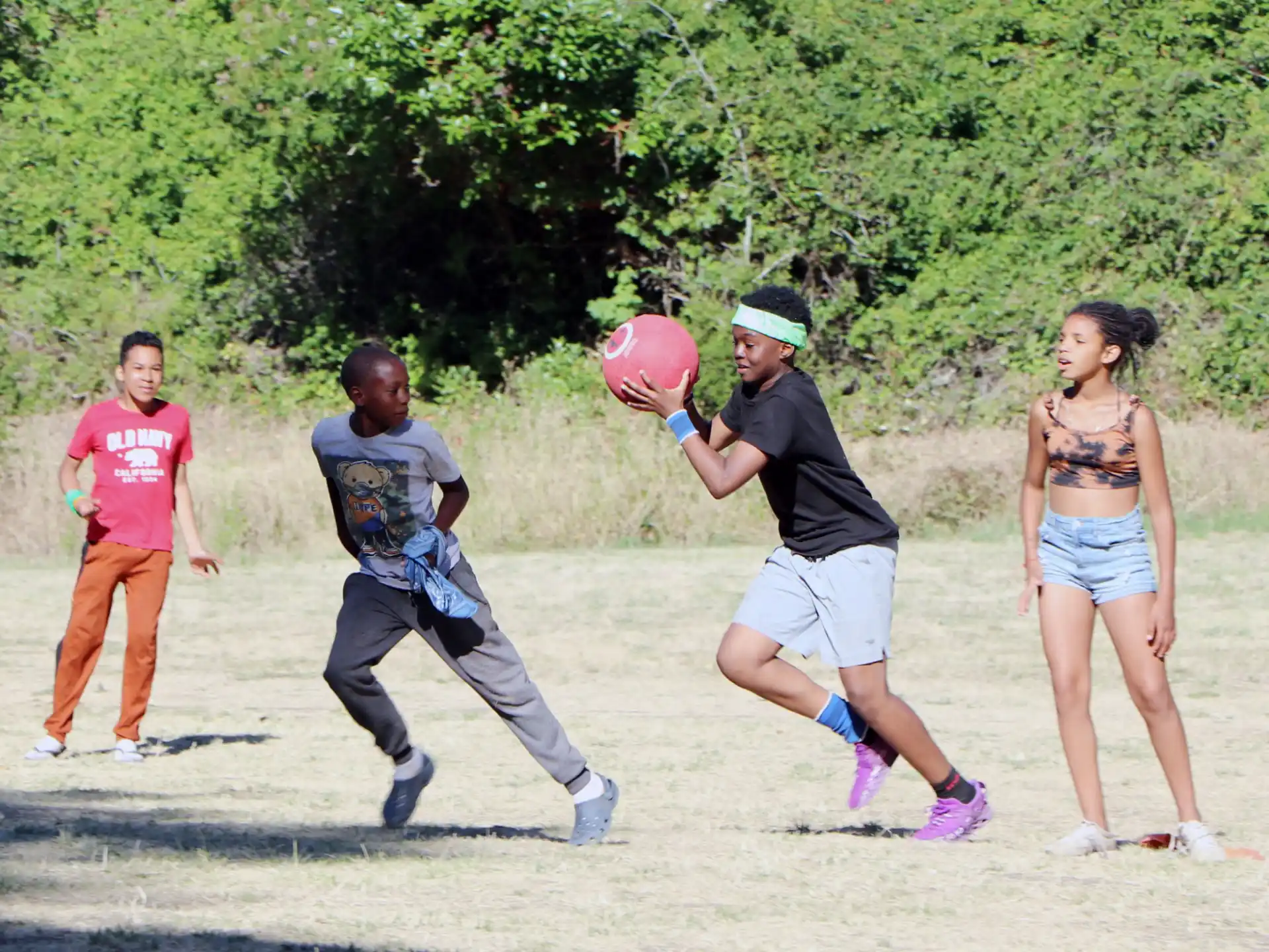 a group of people playing frisbee