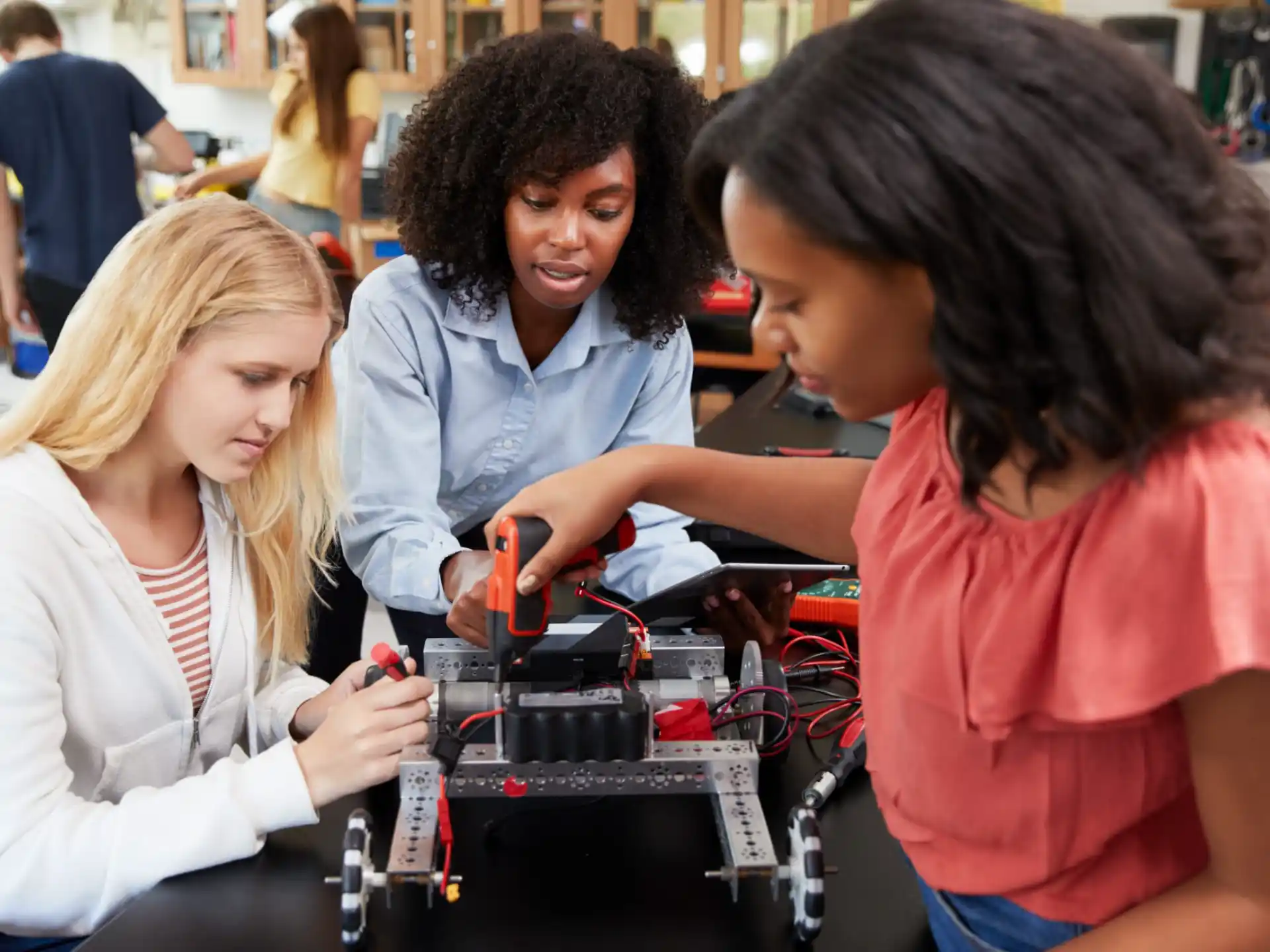 a group of people looking at a machine