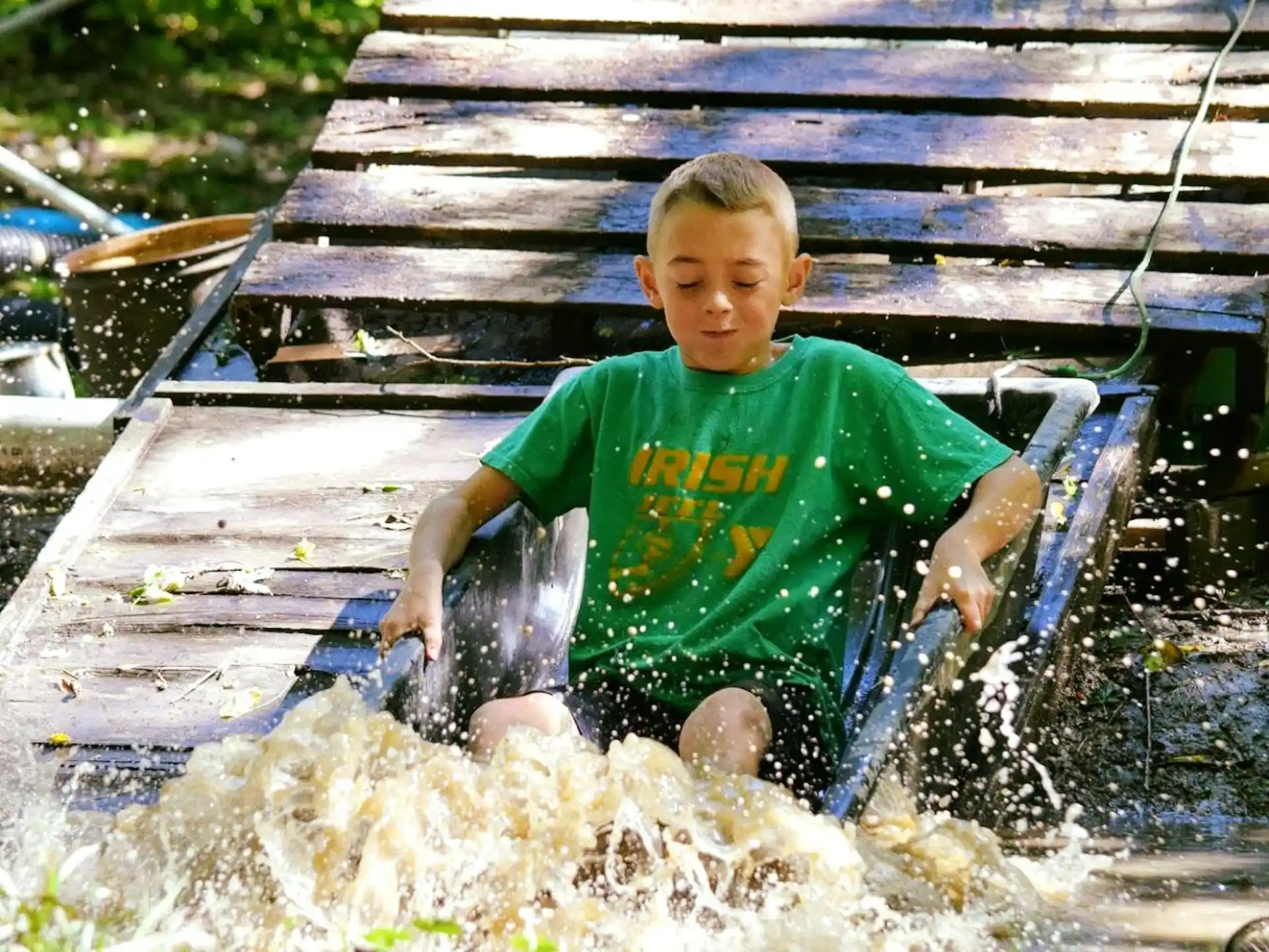 a boy sitting in a small pool