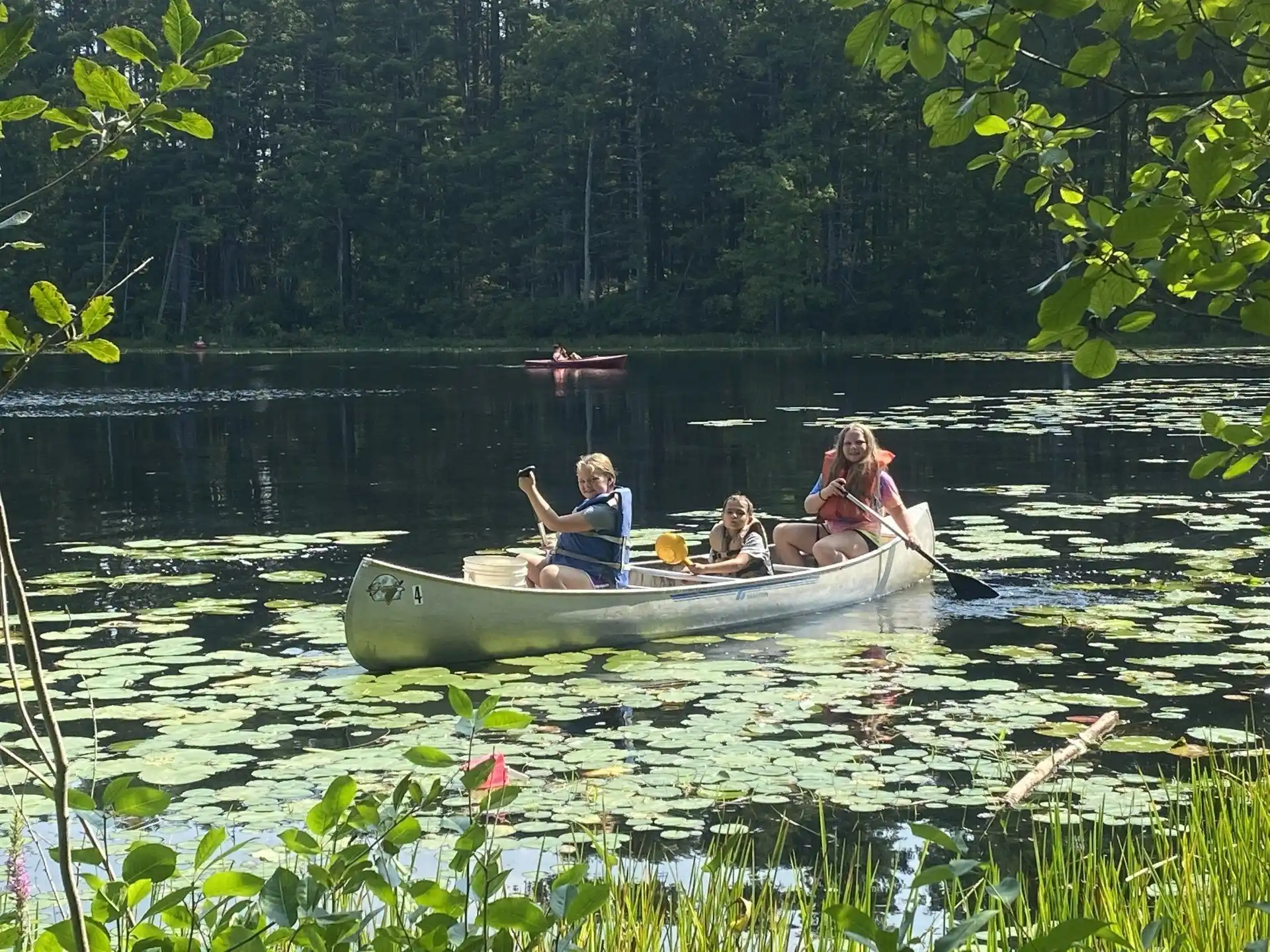 a group of people in a canoe on a lake