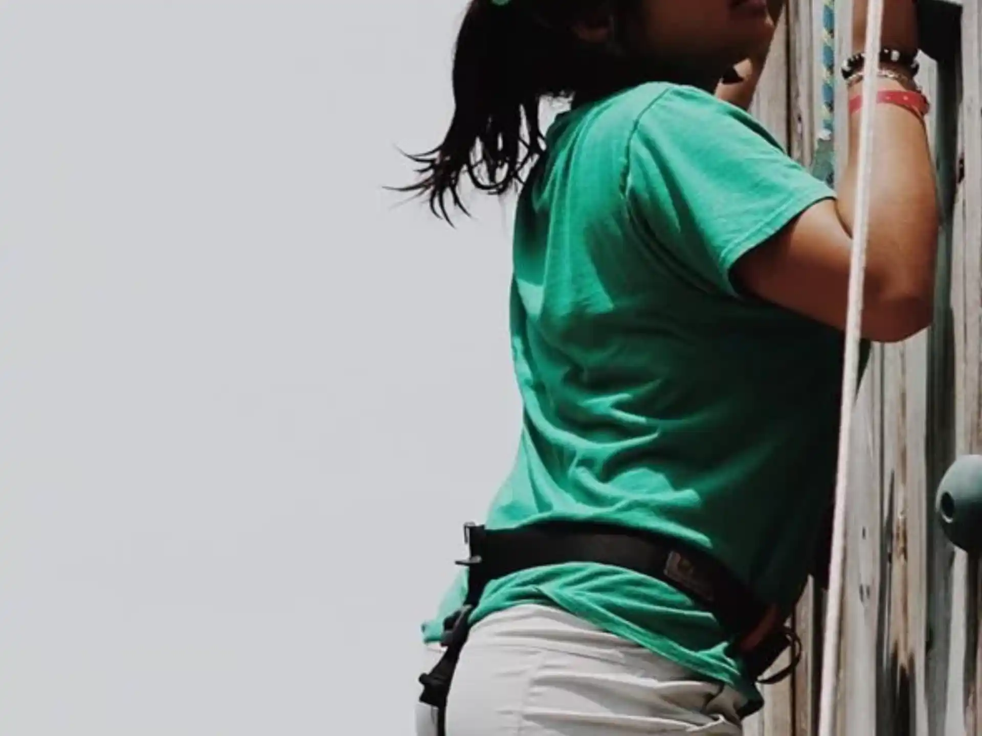 a woman wearing a helmet and harness