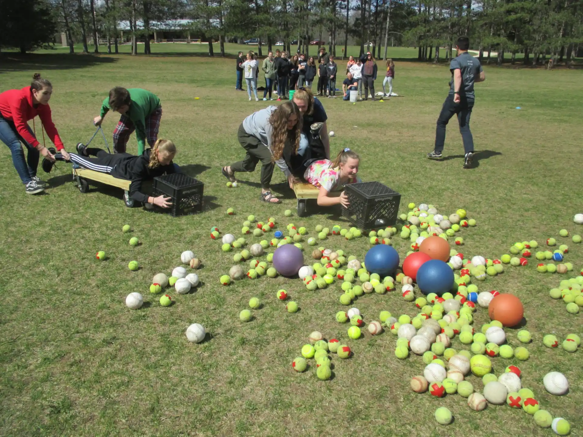 a group of people playing in a field of balls
