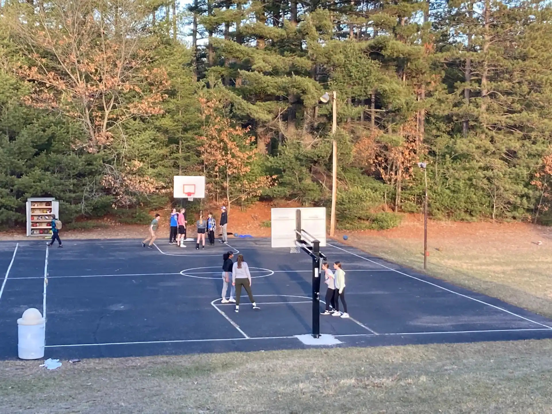 a group of people playing tennis