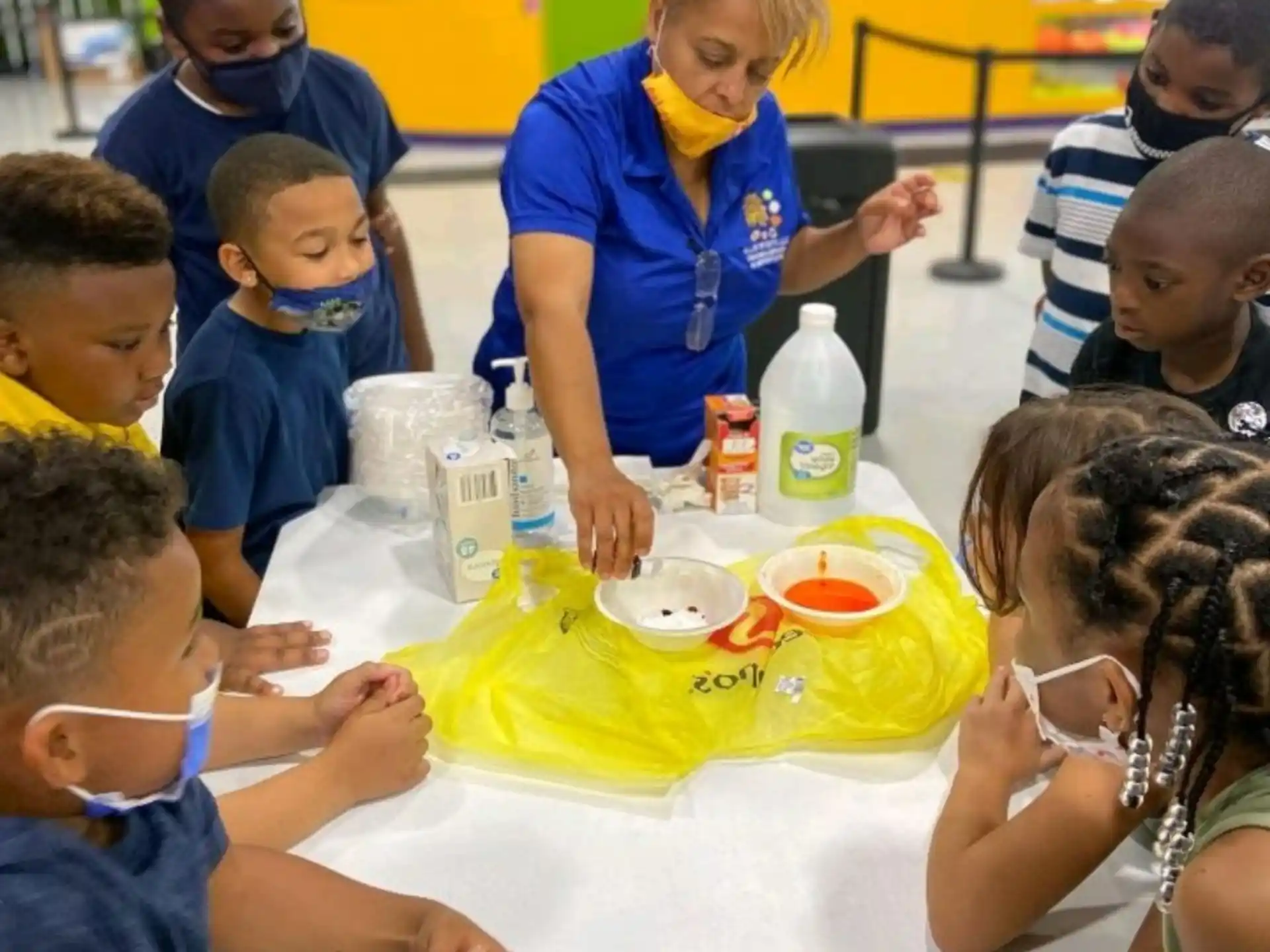 a group of children sitting around a table