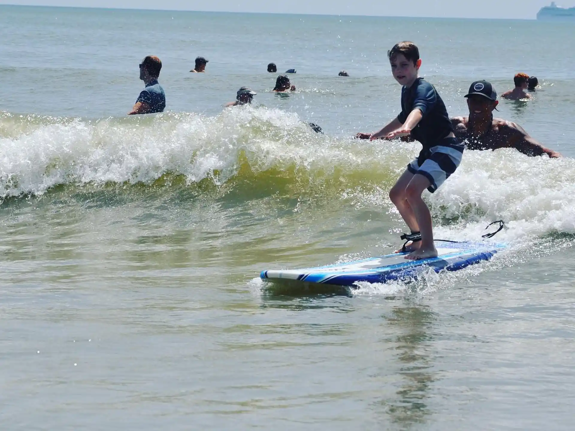a boy surfing on the waves