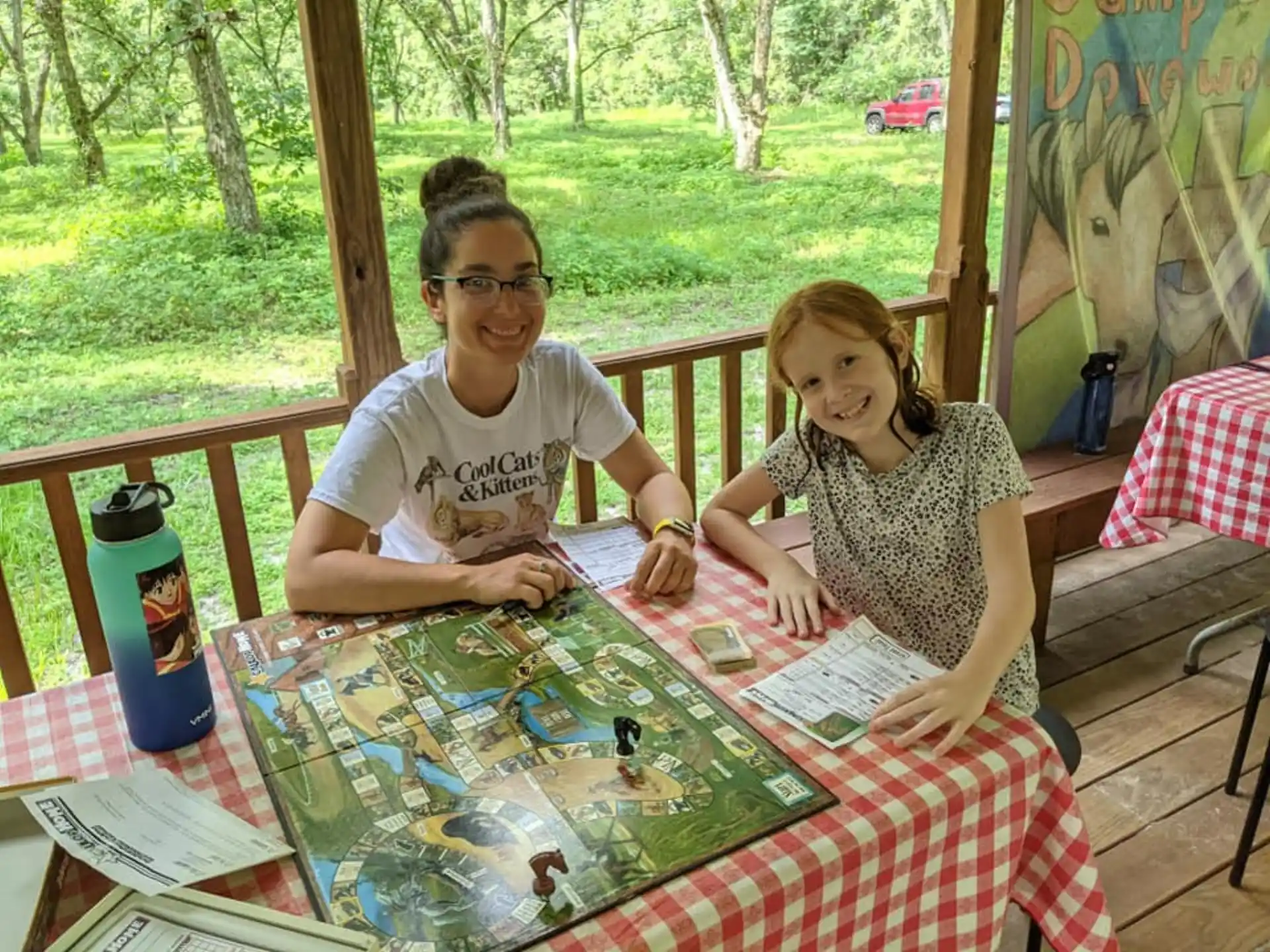 a man and a woman sitting at a table with a board game