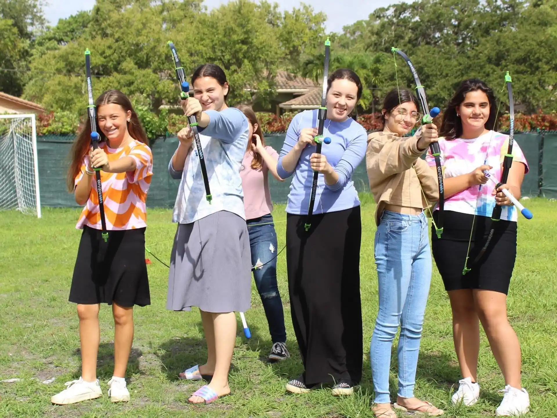 a group of people holding bows and arrows