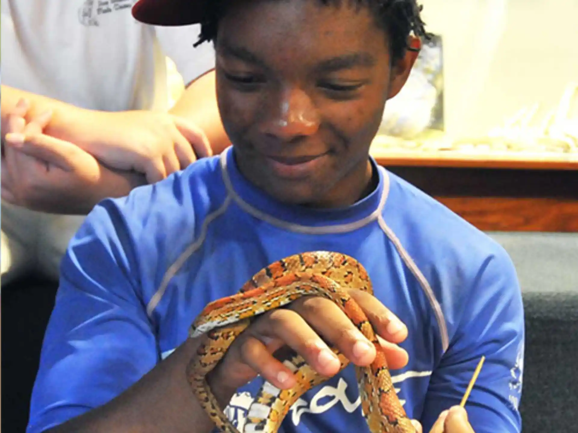 a boy holding a snake