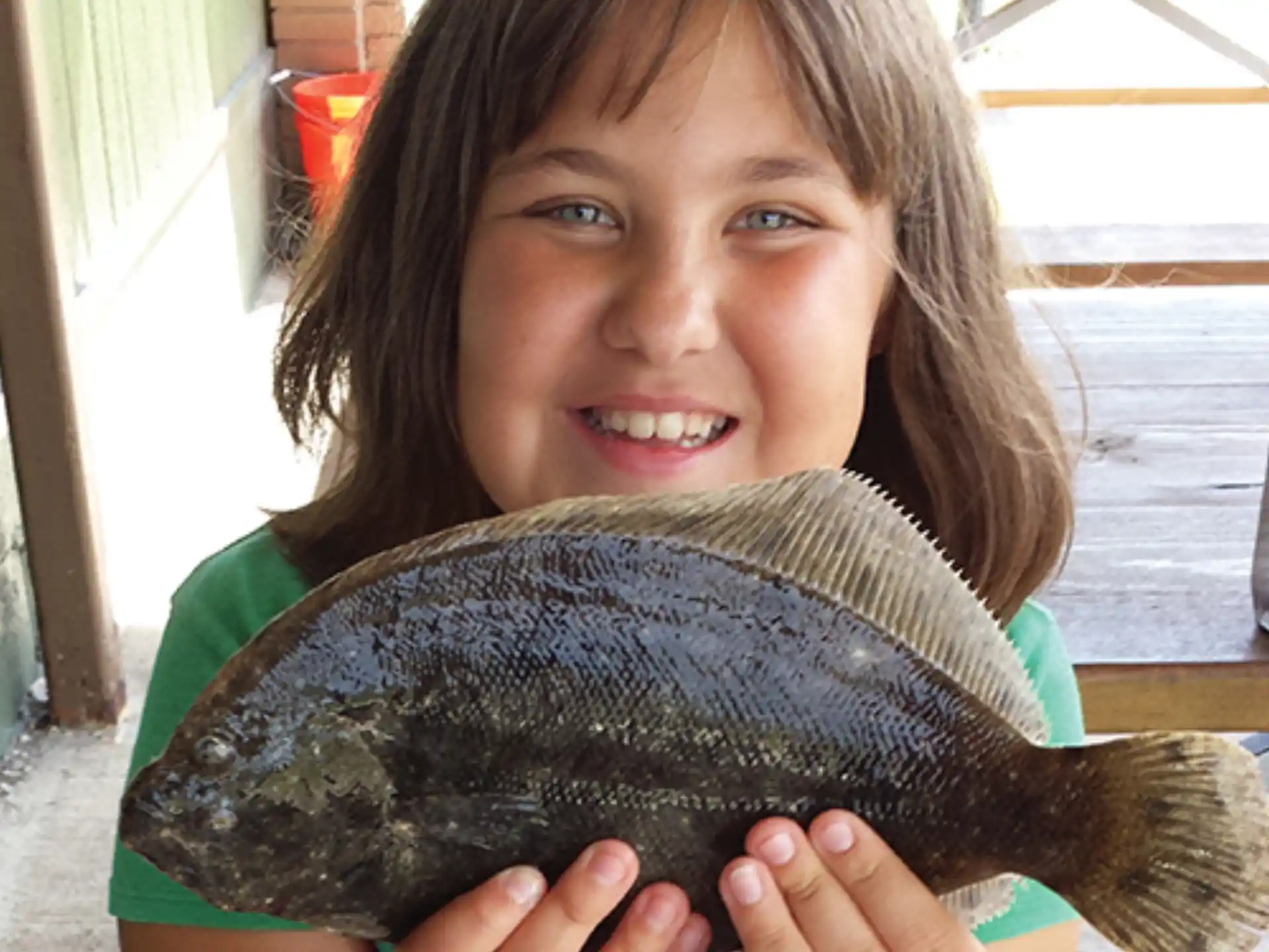a girl holding a large turtle