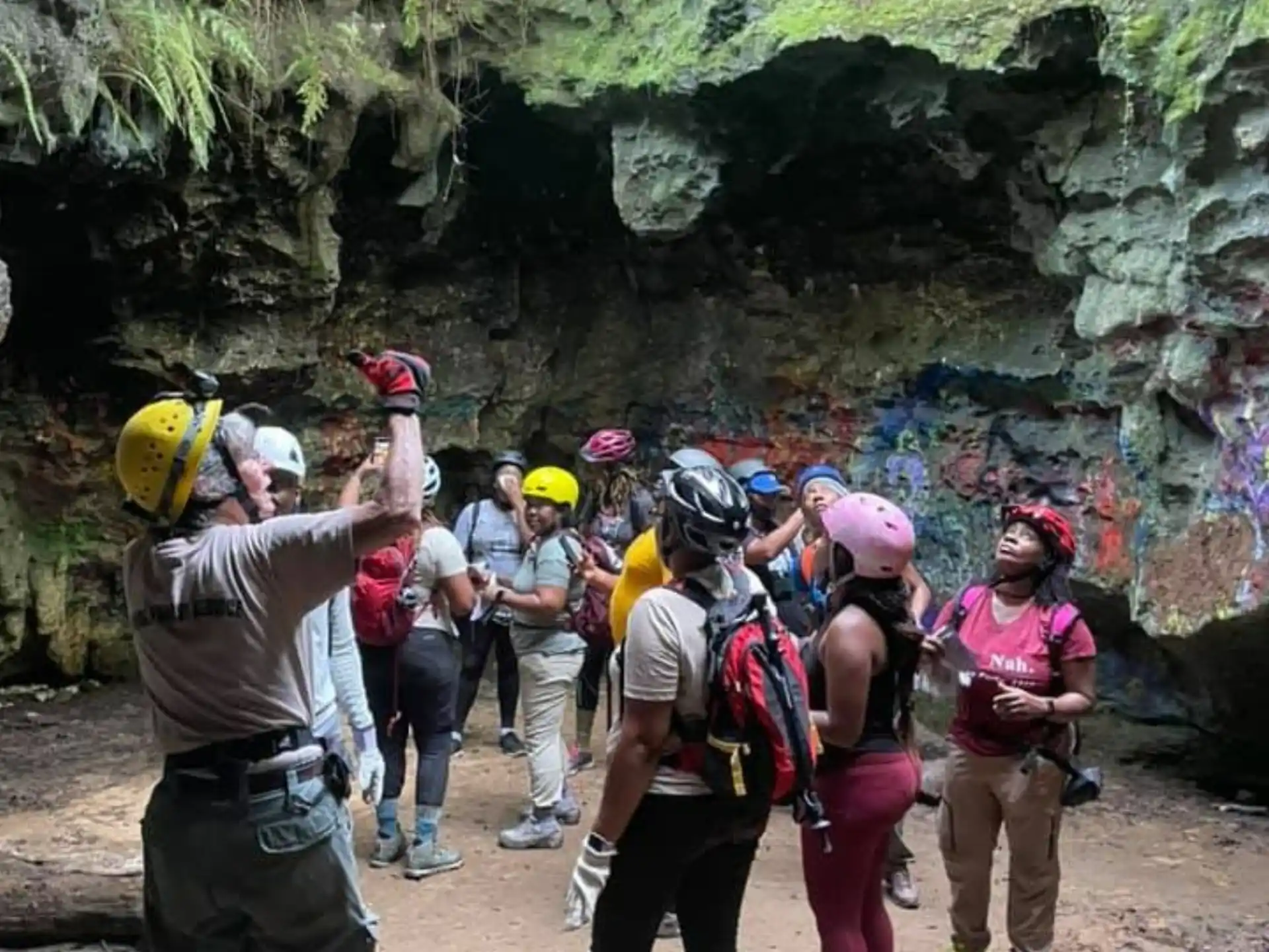 a group of people standing in a cave