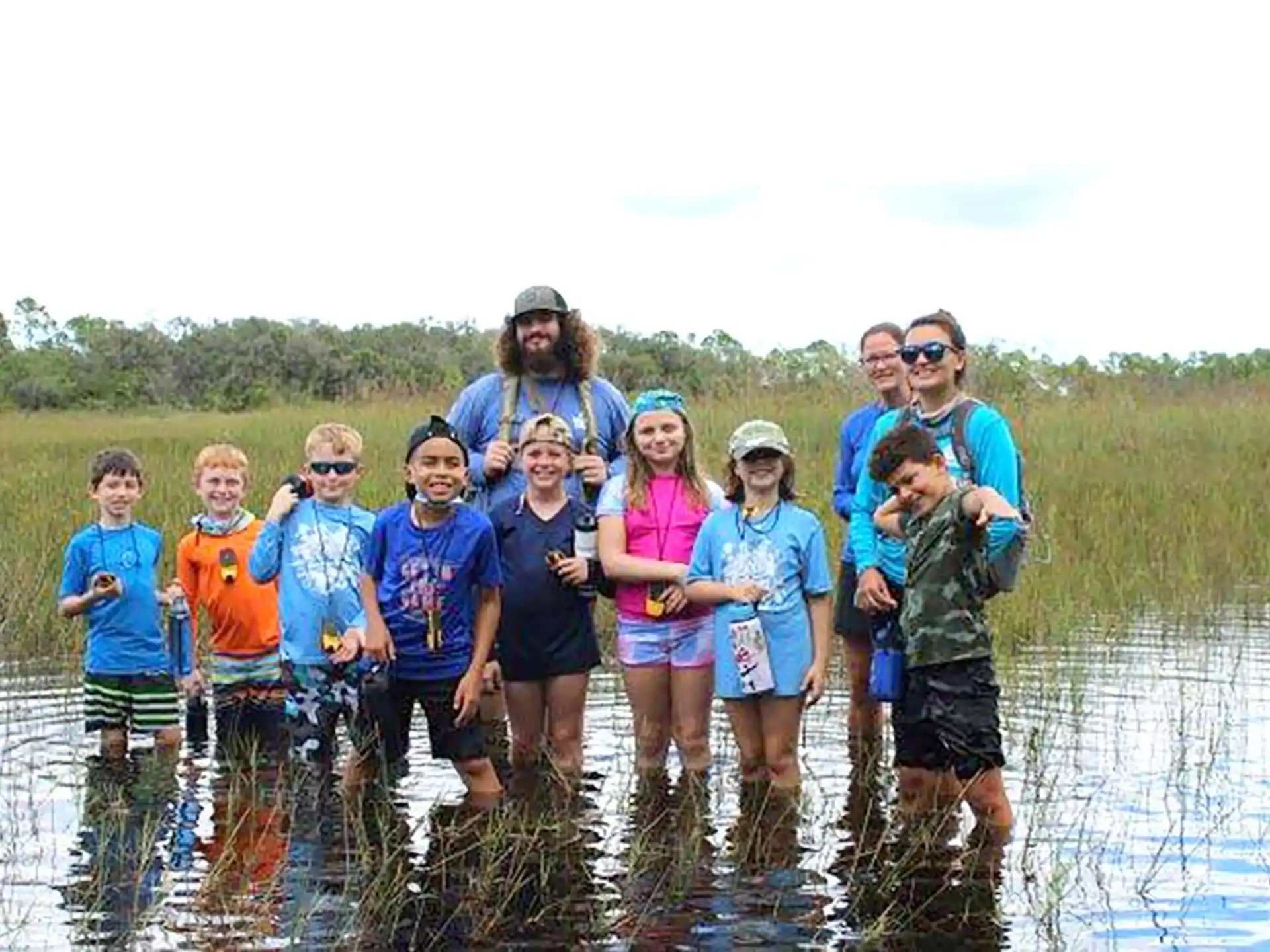 a group of people standing in water
