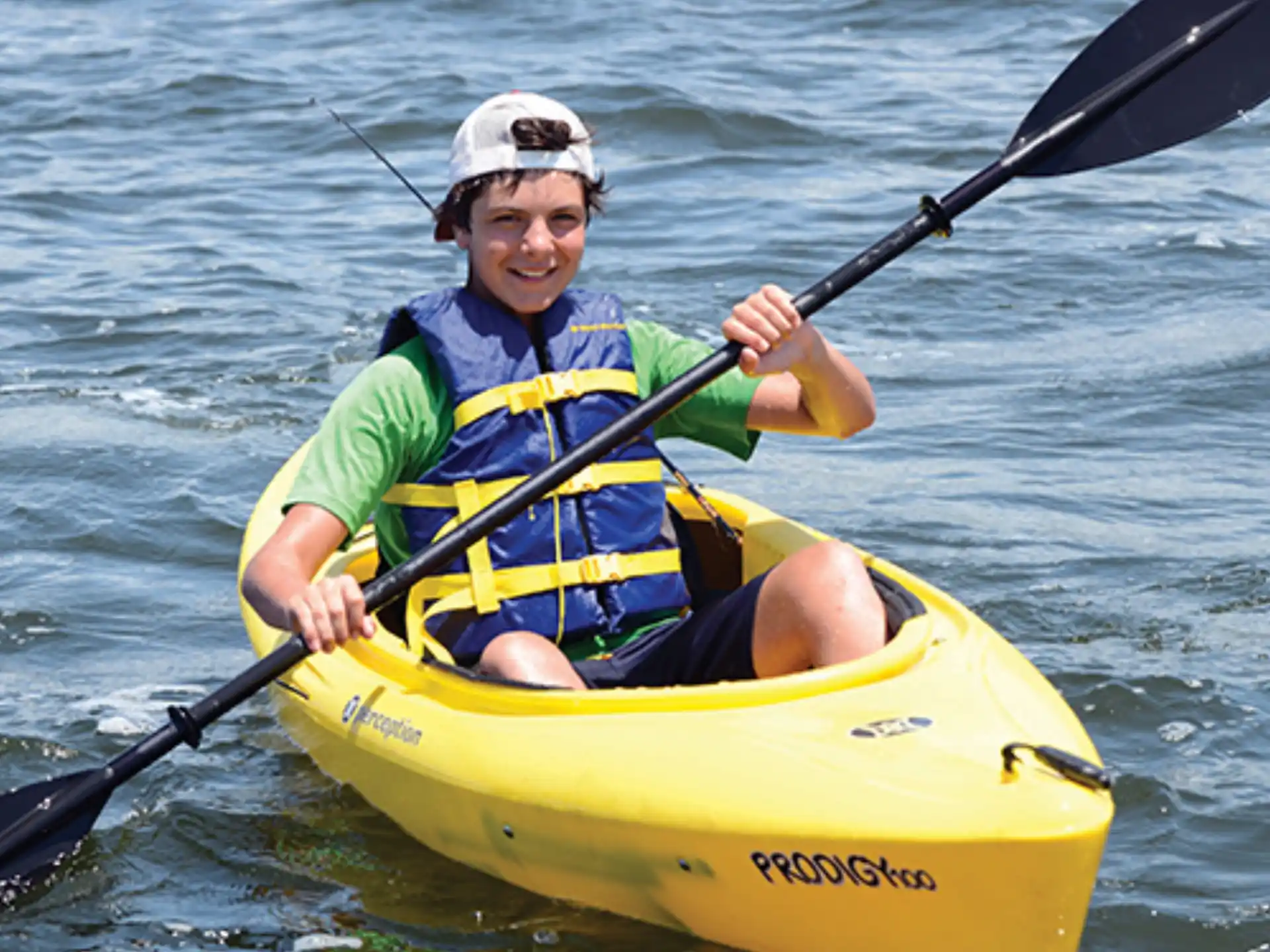 a man in a yellow kayak