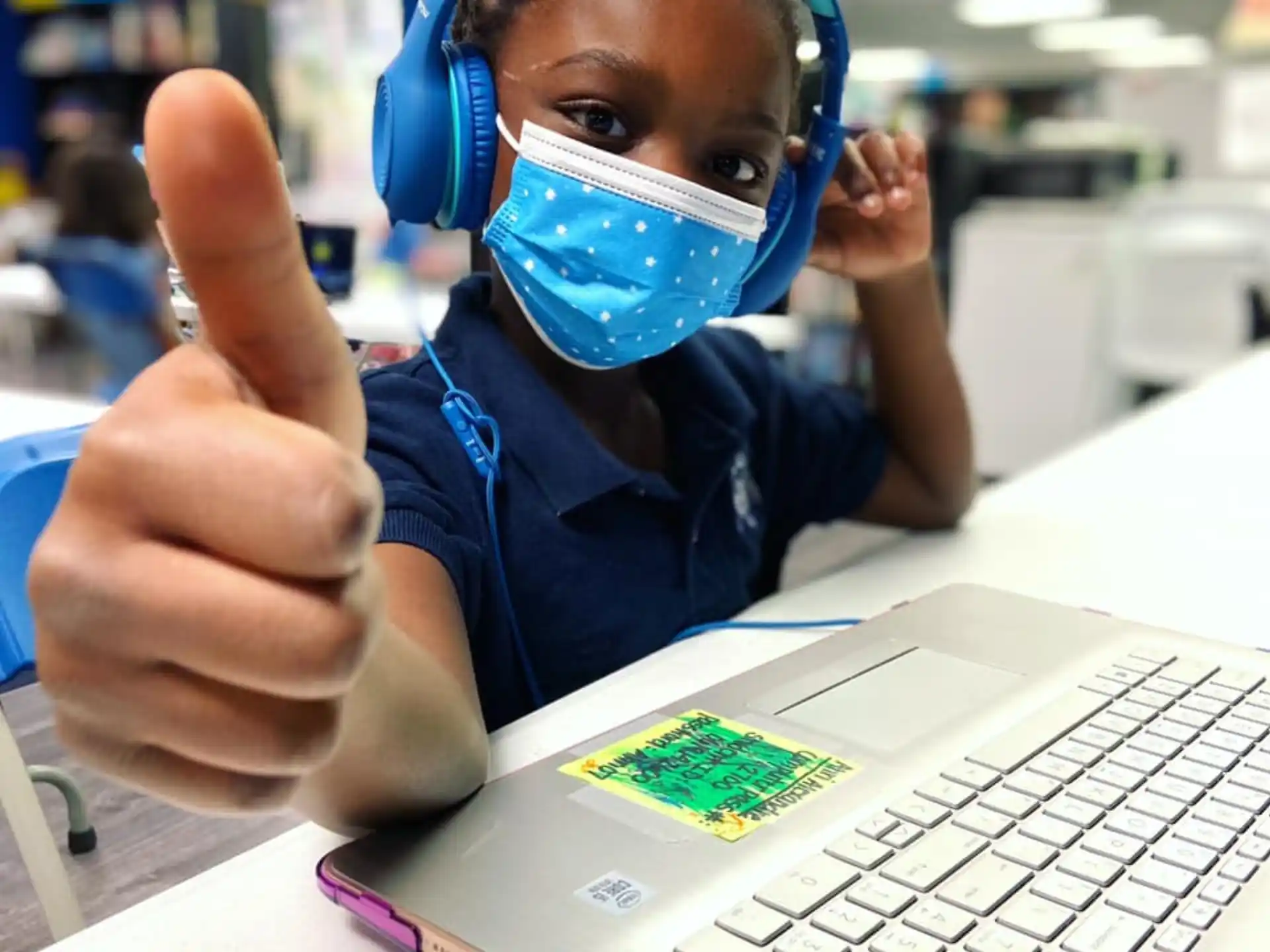 a boy wearing a mask and a blue shirt and a blue headband