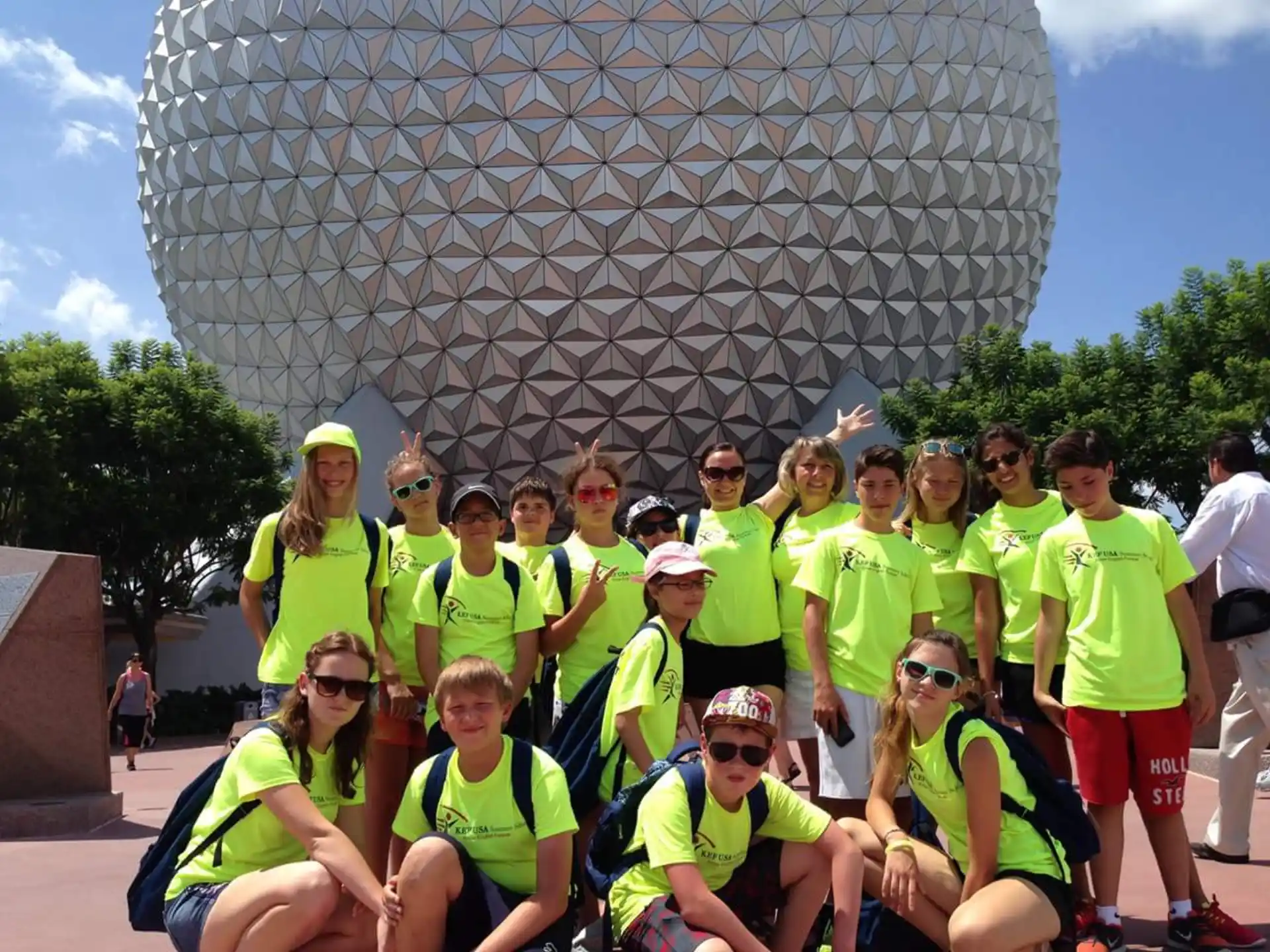 a group of people posing for a photo in front of a large dome