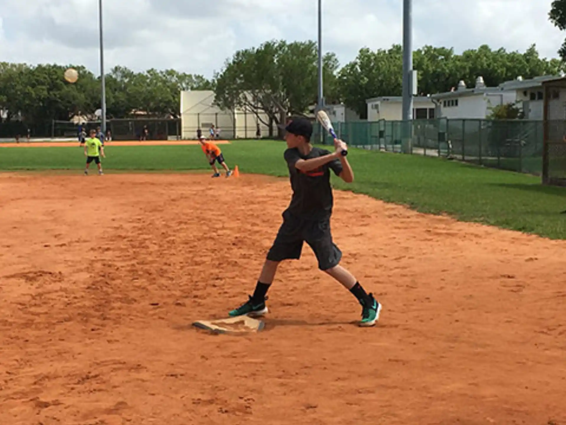 a boy swinging a baseball bat