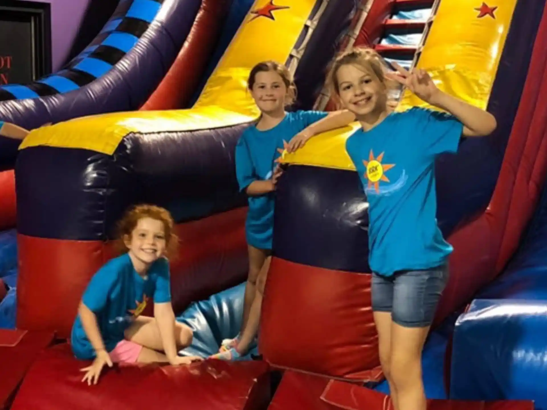 a group of people on a large colorful slide
