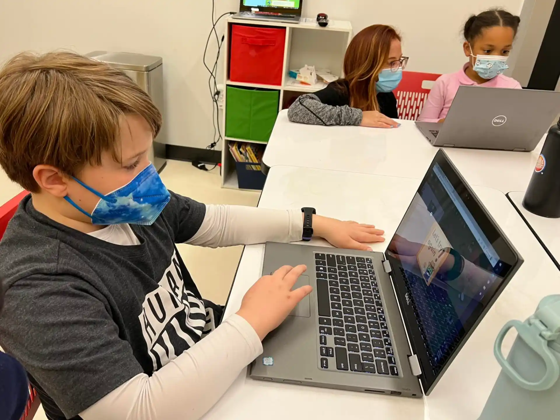 a boy using a laptop