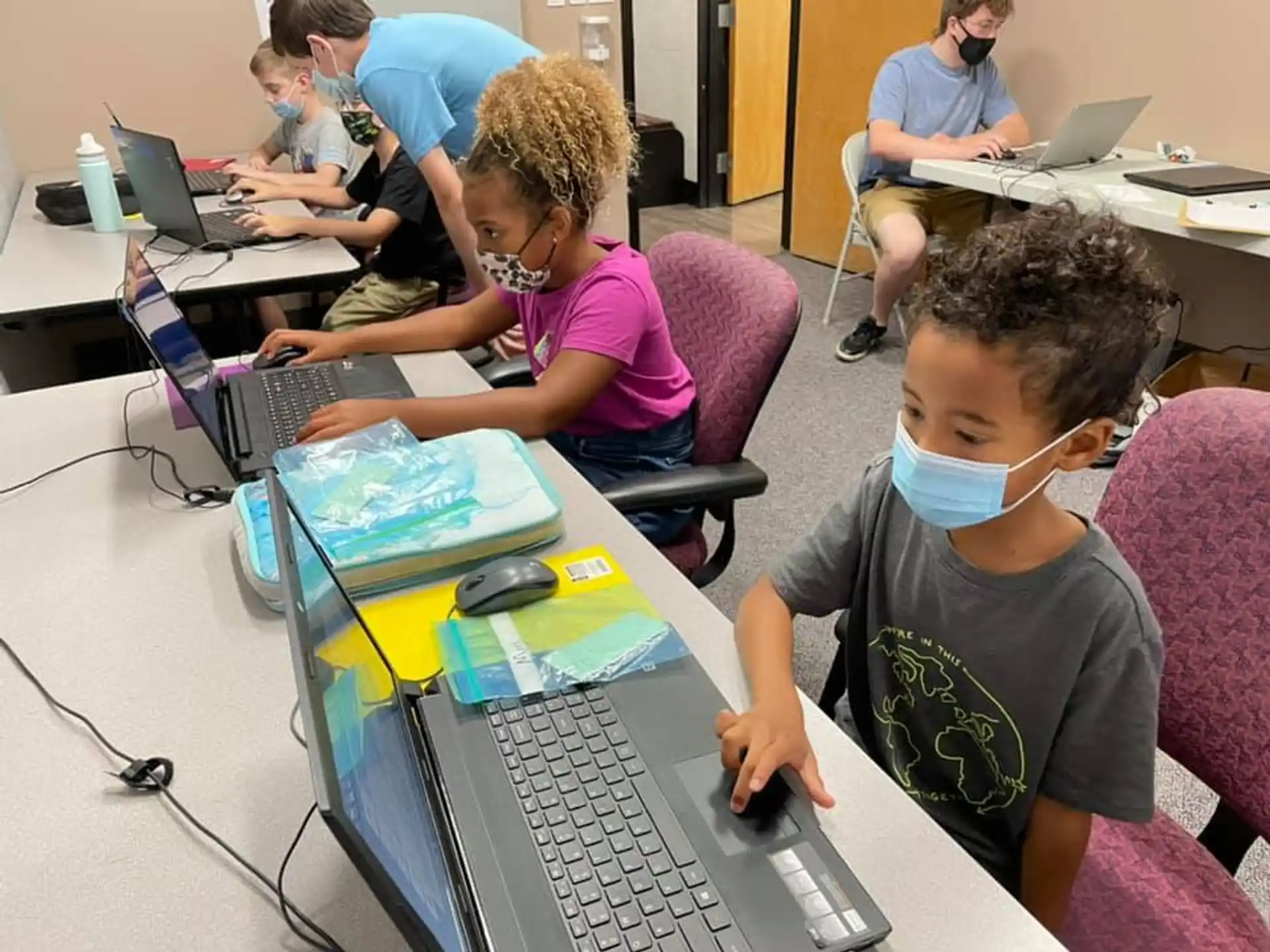 a group of people using laptops