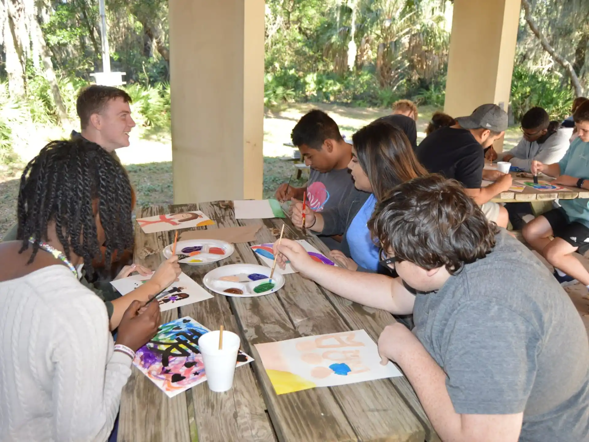 a group of people sitting at a table eating food