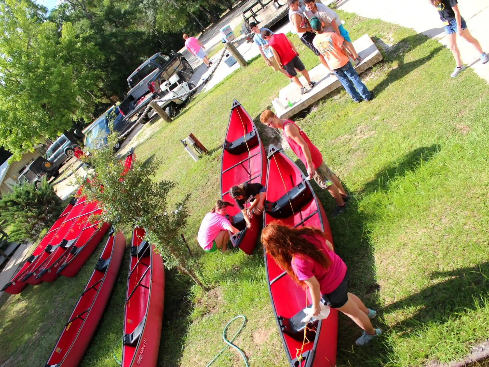 a group of people working on a red boat