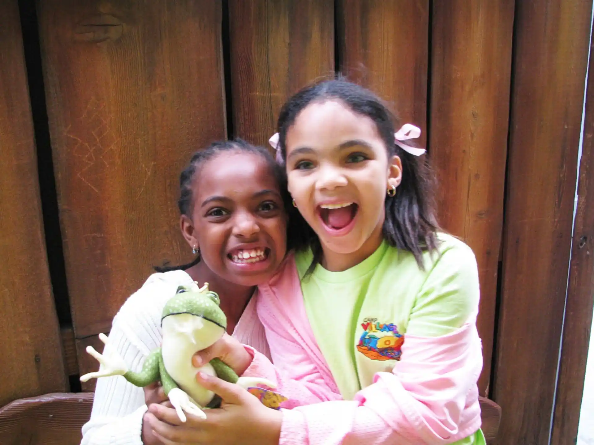 a couple of girls holding an apple