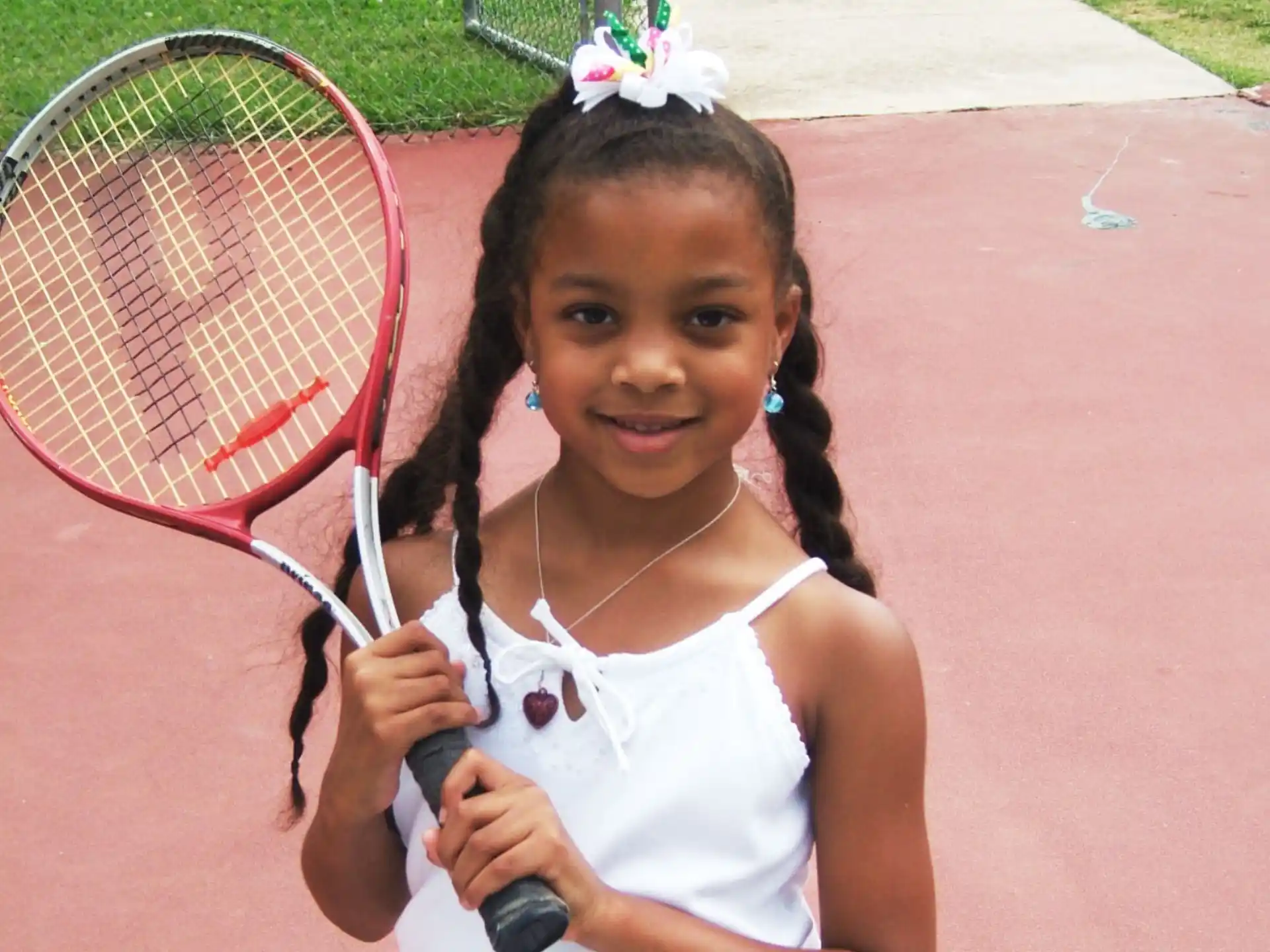 a girl holding a tennis racket