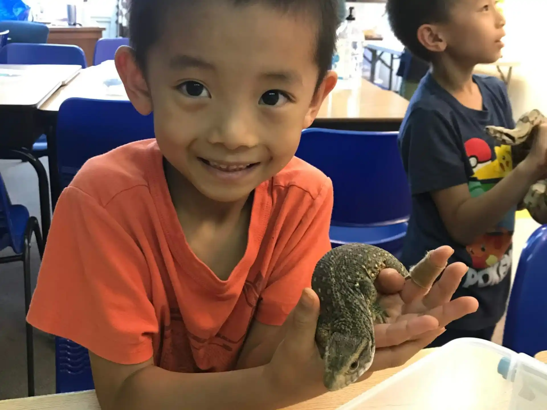 a boy holding a piece of food