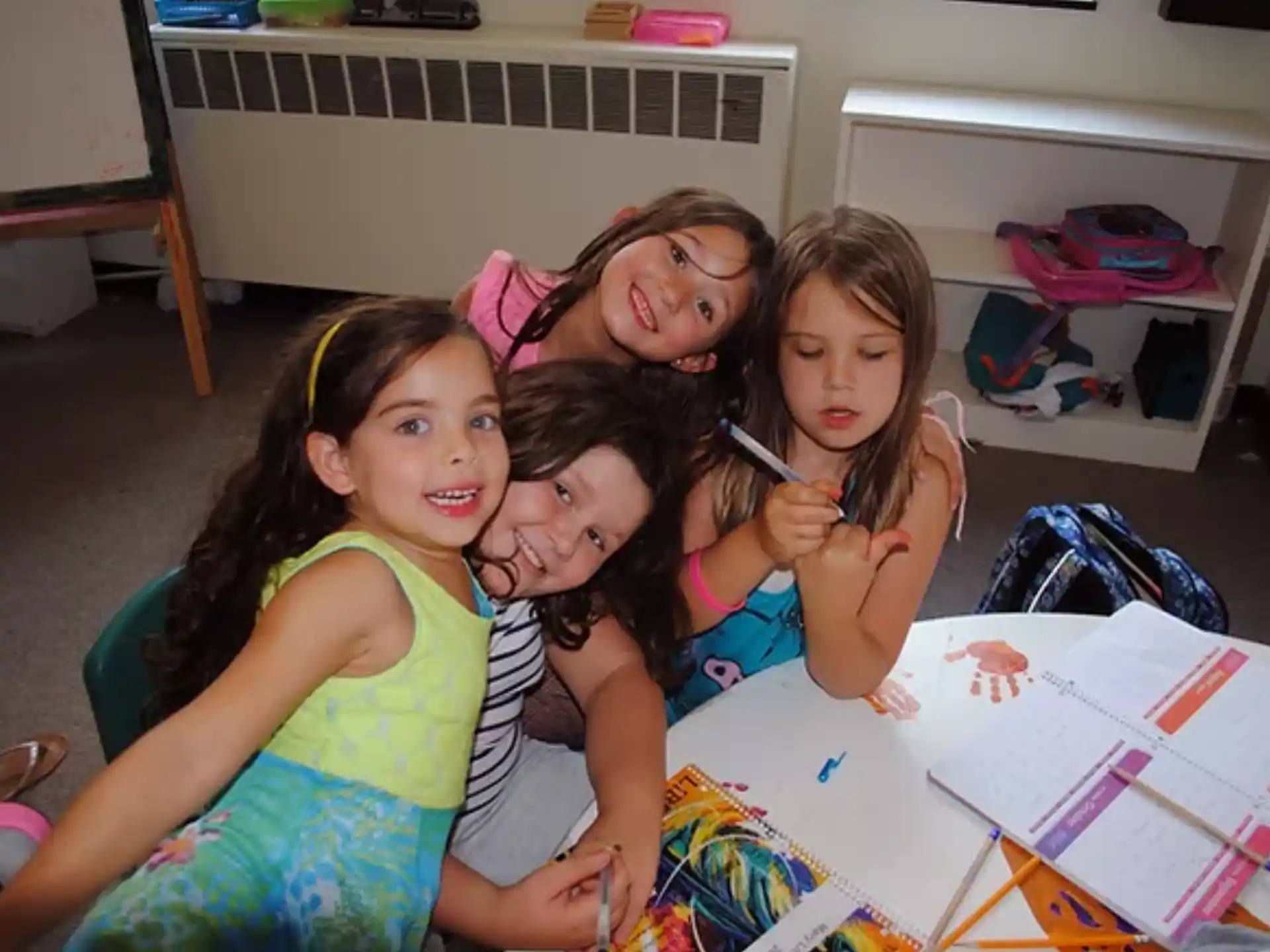 a group of girls sitting at a table