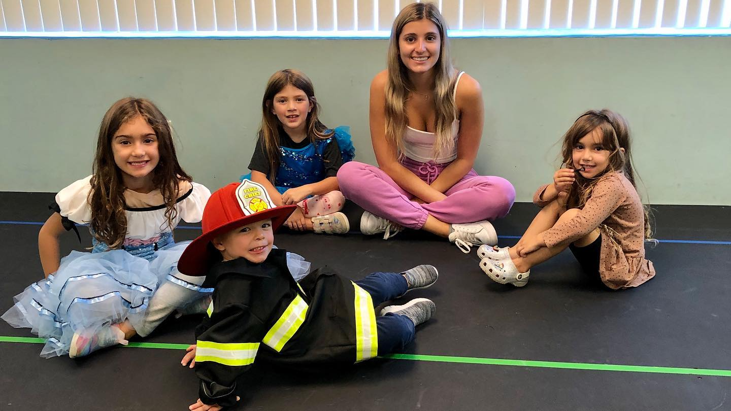 a group of girls sitting on the floor