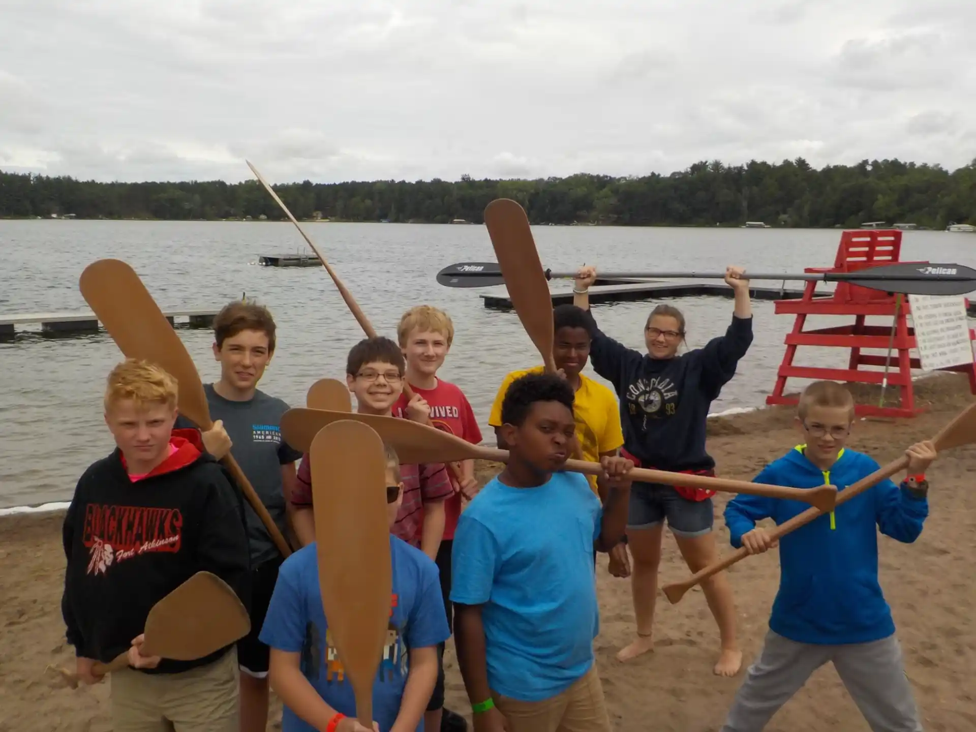 a group of people holding paddles