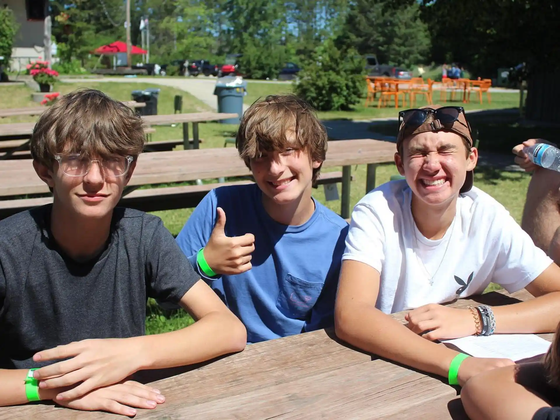 a group of men sitting at a table outside