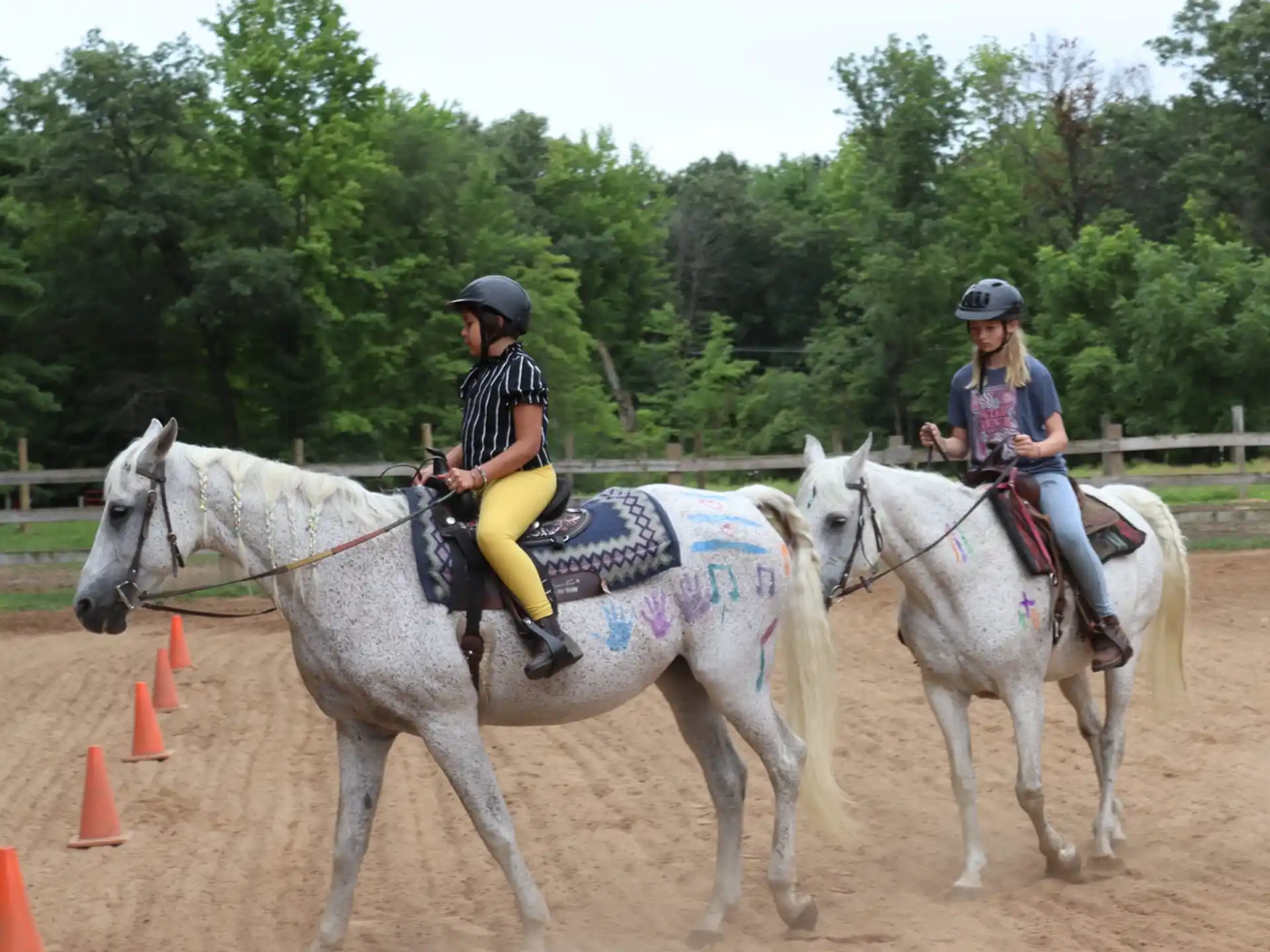 a couple of people riding horses