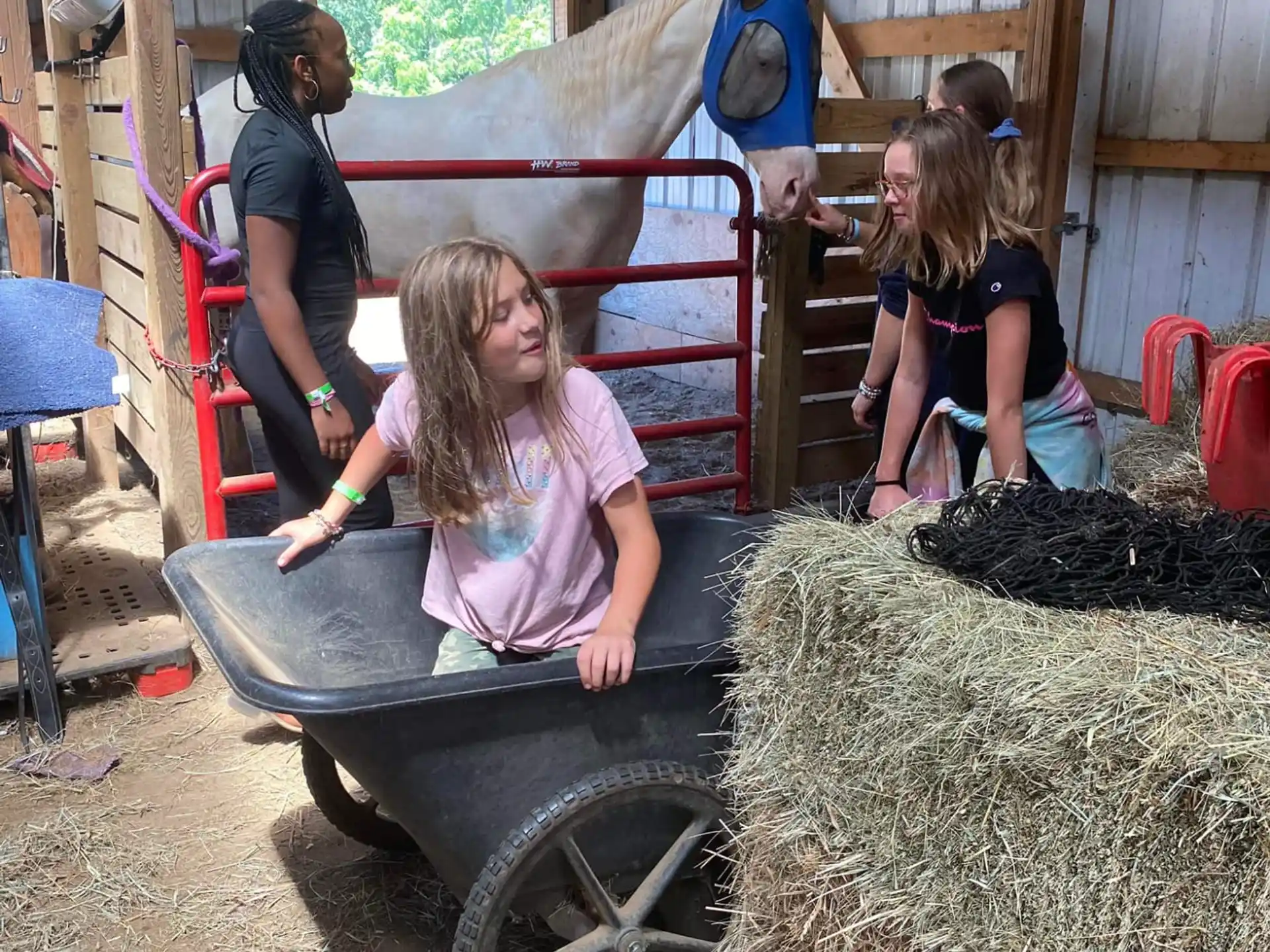 a girl in a wagon with hay