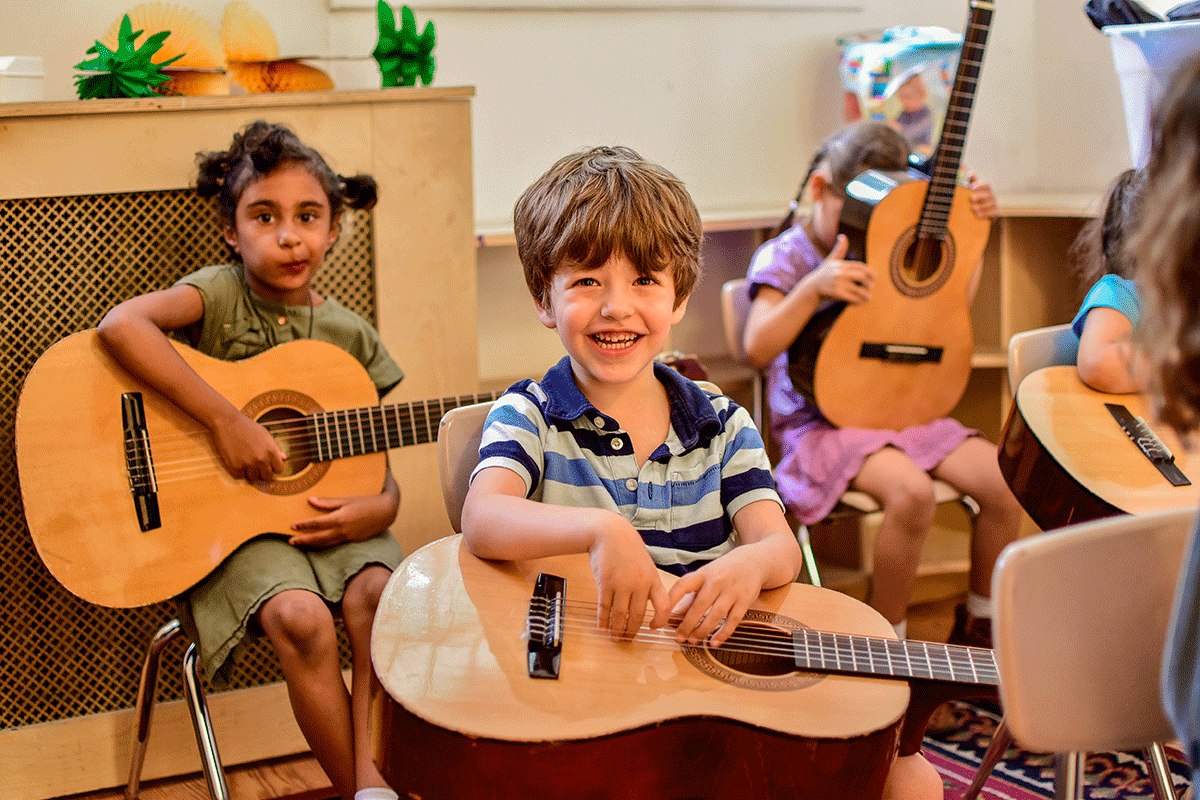 a group of kids playing guitars