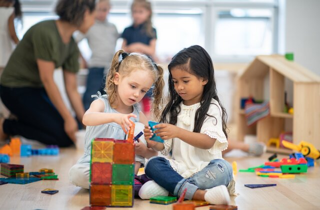 a few young girls playing with toys